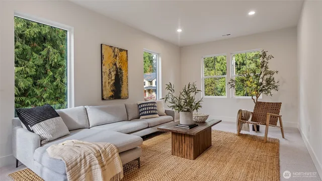 a living room with furniture and a potted plant