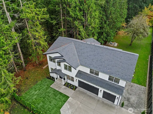 an aerial view of a house with yard