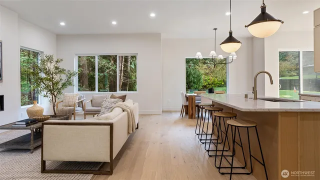 a living room with furniture a fireplace and a chandelier