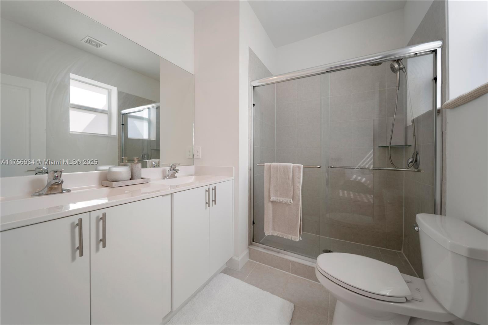 26431 Southwest 148th Avenue Homestead, FL 33032 - Photo 14 of 29 a bathroom with a sink a toilet and shower