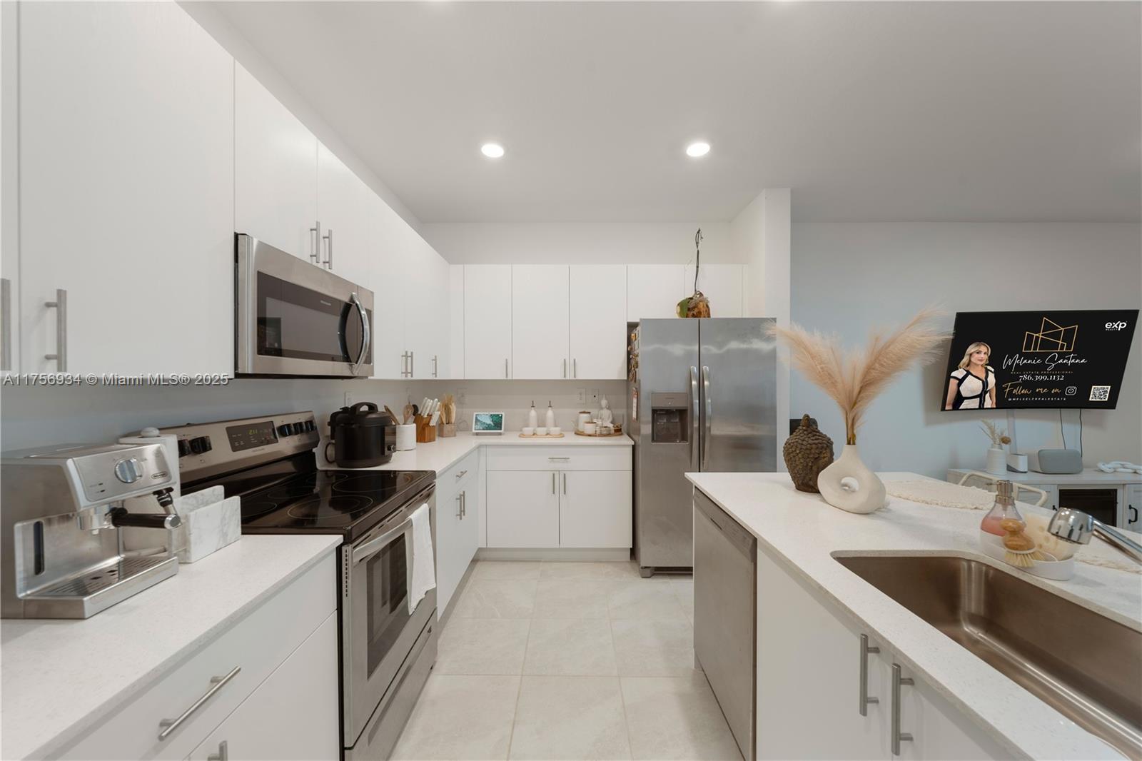 26431 Southwest 148th Avenue Homestead, FL 33032 - Photo 4 of 29 a kitchen with a sink stove top oven and refrigerator