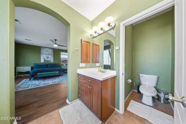 a bathroom with a sink a toilet and mirror