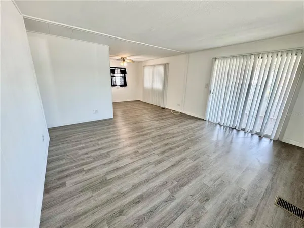 a view of hallway with wooden floor