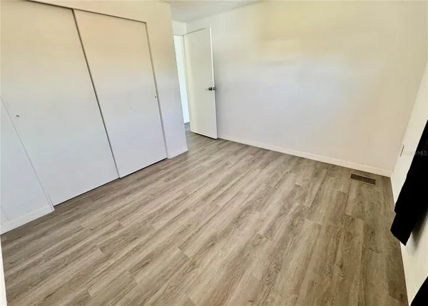 a view of a room with wooden floor