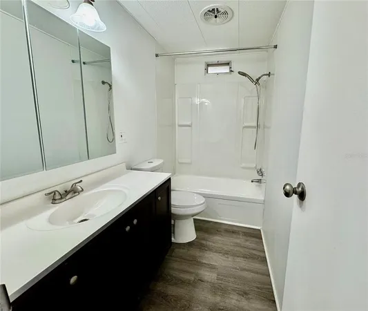 a bathroom with a double vanity sink toilet mirror and shower