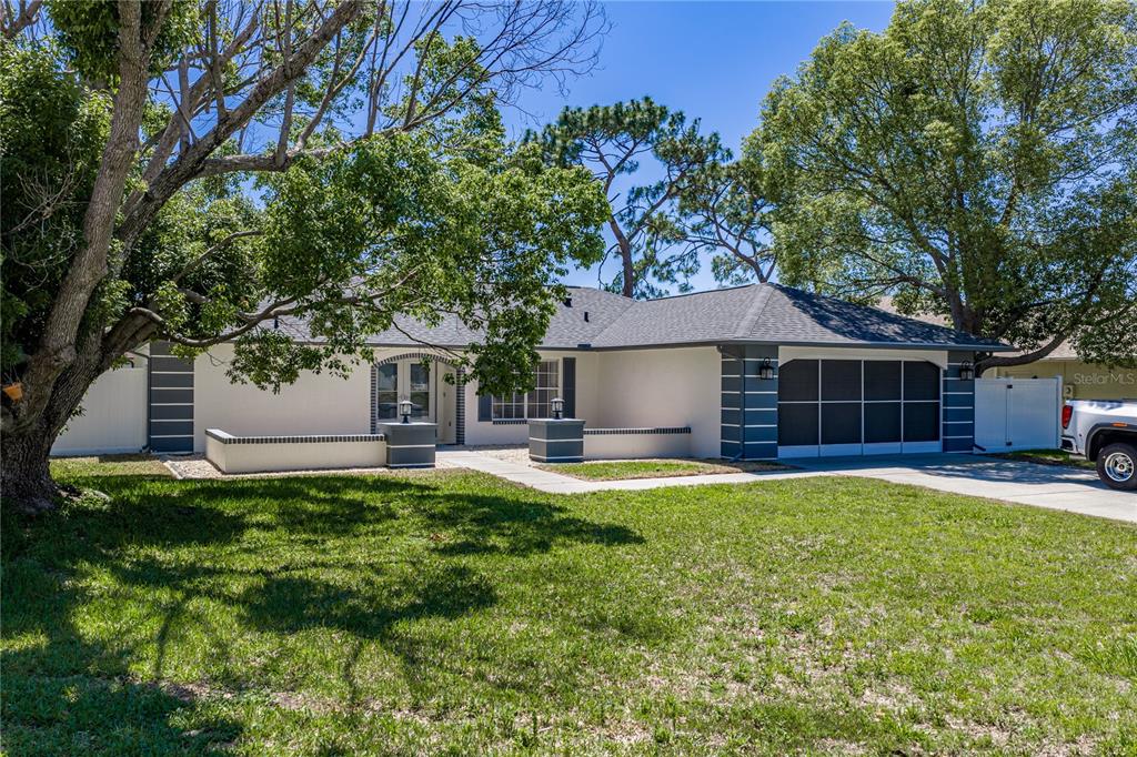 7435 Kilbride Court Weeki Wachee, FL 34613 - Photo 3 of 67 a front view of a house with a garden