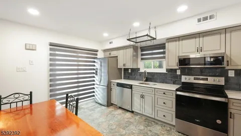 a kitchen with stainless steel appliances a stove sink and microwave
