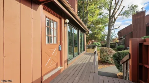 a view of balcony with furniture and garden