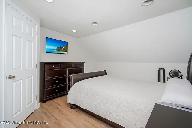 a bedroom with a bed and a dresser