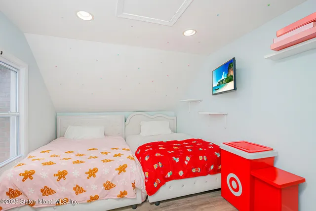 a bedroom with a bed and a lamp on table