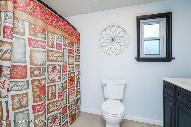 a white toilet sitting next to a shower curtain