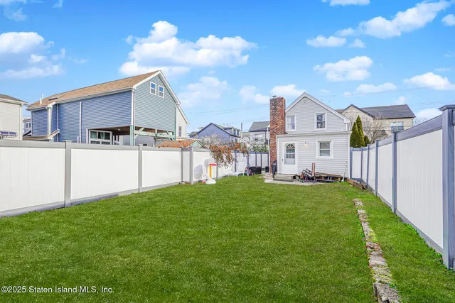 a view of a house with a yard and a garden