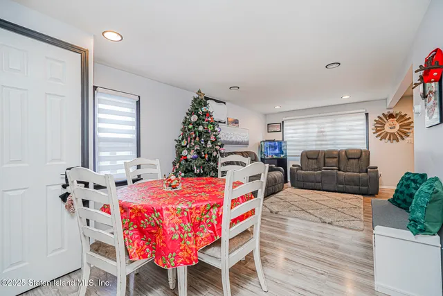 a living room with furniture a couch and a potted plant