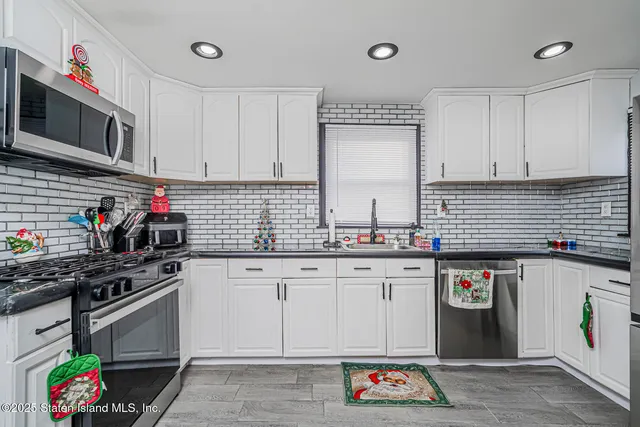 a kitchen with granite countertop a stove and cabinets
