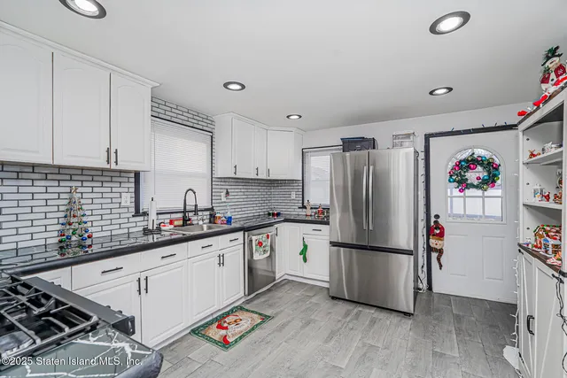 a kitchen with stainless steel appliances a refrigerator sink and cabinets