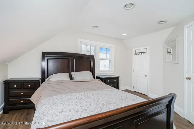 a bedroom with a bed and a night stand