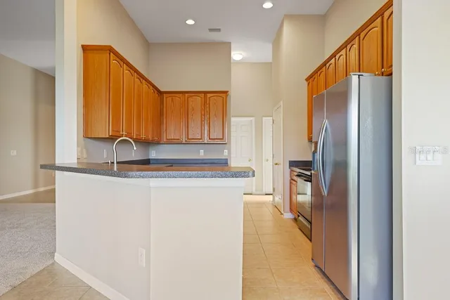 a kitchen with stainless steel appliances a refrigerator and a sink