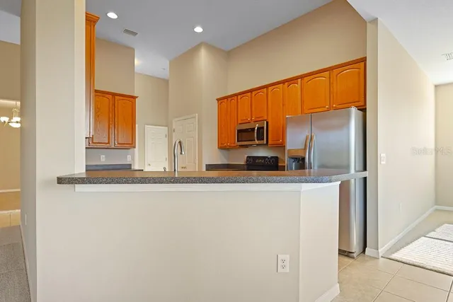 a kitchen with stainless steel appliances granite countertop wooden cabinets a sink and dishwasher