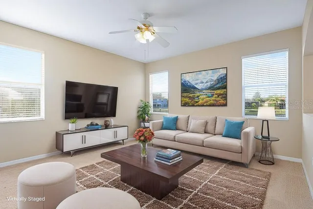a view of a kitchen with wooden floor and a chandelier fan