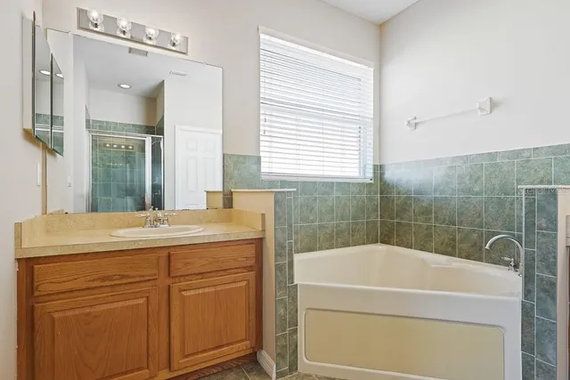 a bathroom with a shower sink and mirror