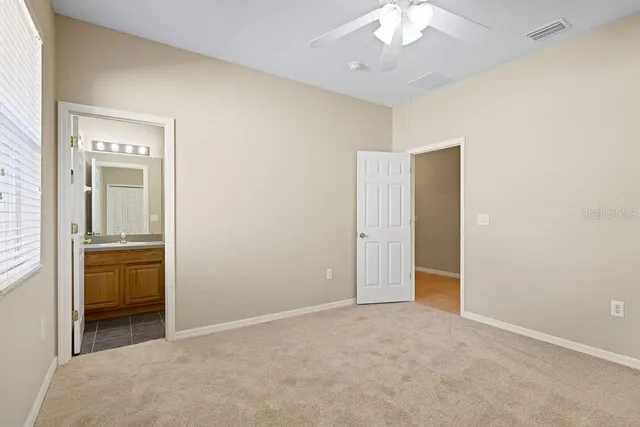 a bathroom with a granite countertop toilet a sink and a bathtub