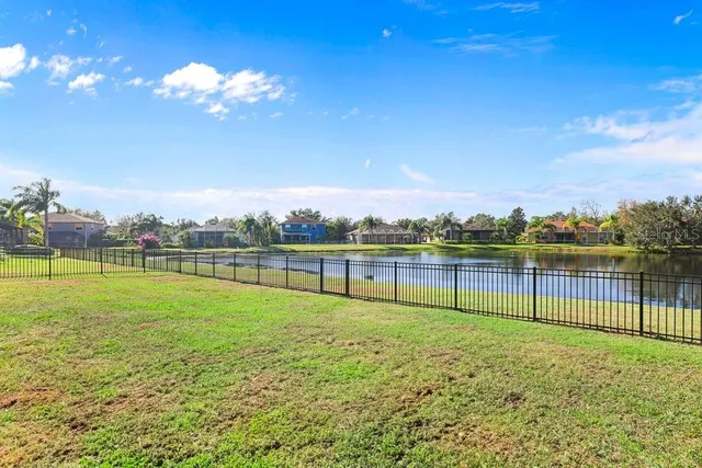 a sign board with tall buildings in the background