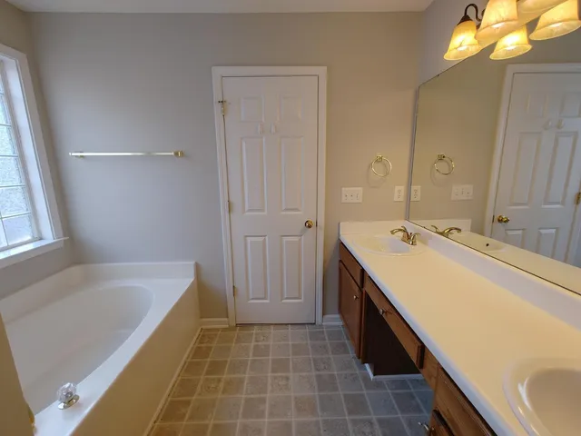 a bath tub sitting next to a window