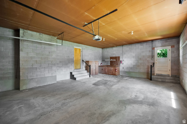 1783 South 500 East Bountiful, UT 84010 - Photo 24 of 30 Spacious garage with concrete block walls, concrete flooring, built-in wooden cabinetry