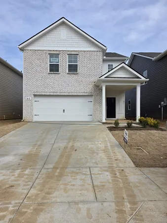 a front view of a house with garage