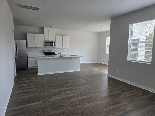 a kitchen with stainless steel appliances a sink a stove a refrigerator and cabinets