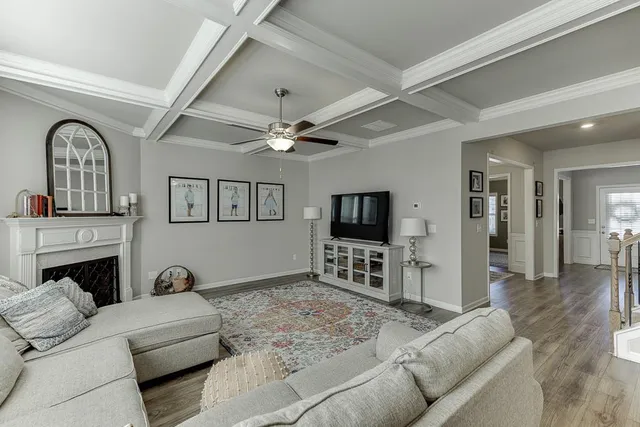 a kitchen with a dining table chairs wooden floor appliances and cabinets