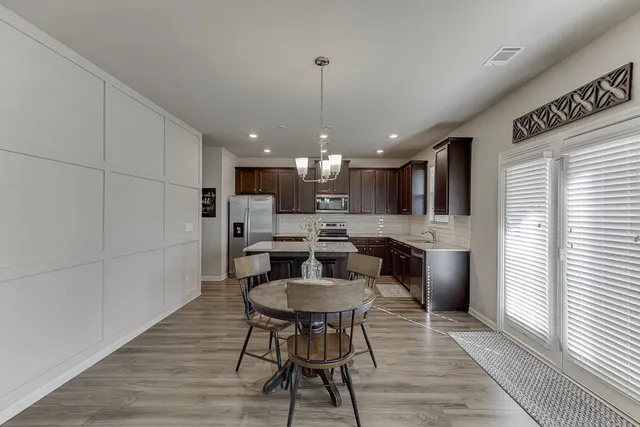 a kitchen with a stove a sink and a refrigerator