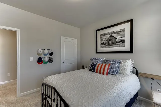 a spacious bedroom with a bed and a ceiling fan