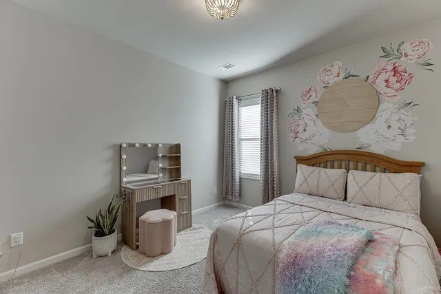 a bedroom with a bed and a television