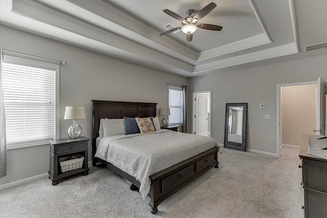 a spacious bathroom with double vanity and a mirror