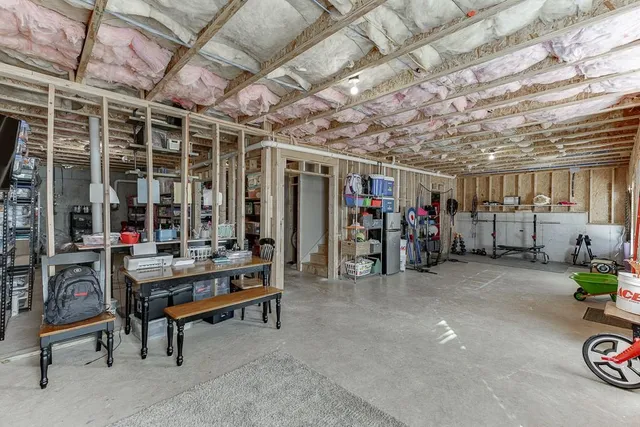 an aerial view of a house with a mountain