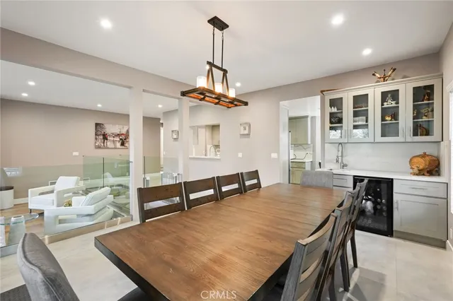 a living room with furniture a chandelier and a dining table