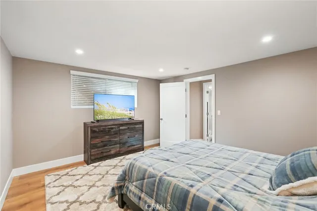 a bathroom with a granite countertop sink a toilet a mirror and shower