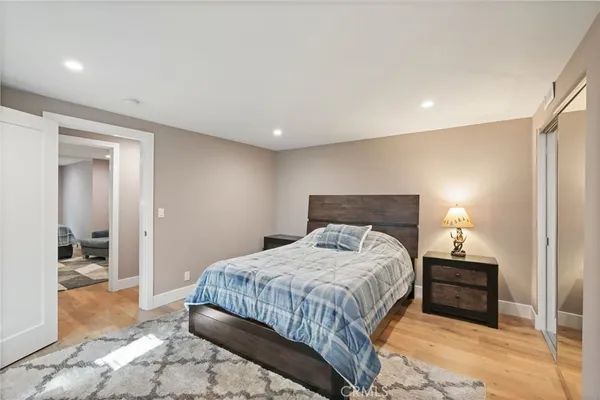 a bedroom with a bed and a chandelier