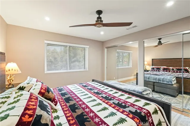 a bedroom with double bed and a flat screen tv