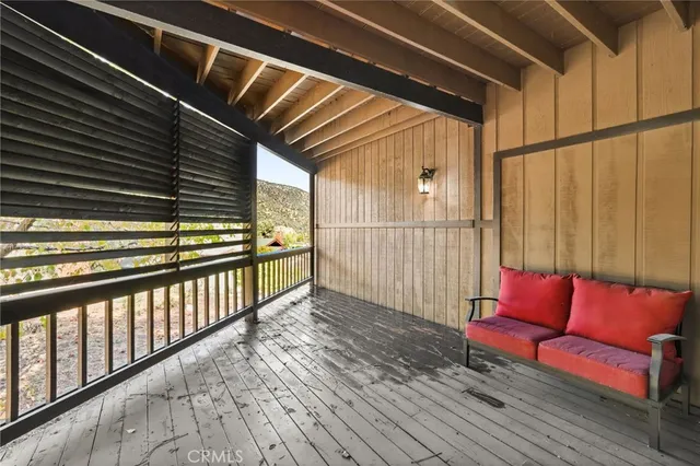 an aerial view of a house with a yard and tree s