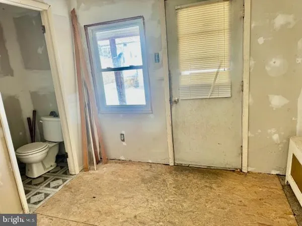 a bathroom with a granite countertop toilet a sink and a mirror