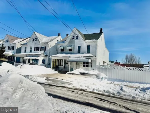 a large white bed in a house