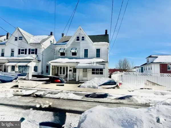 a view of the house with swimming pool and sitting area