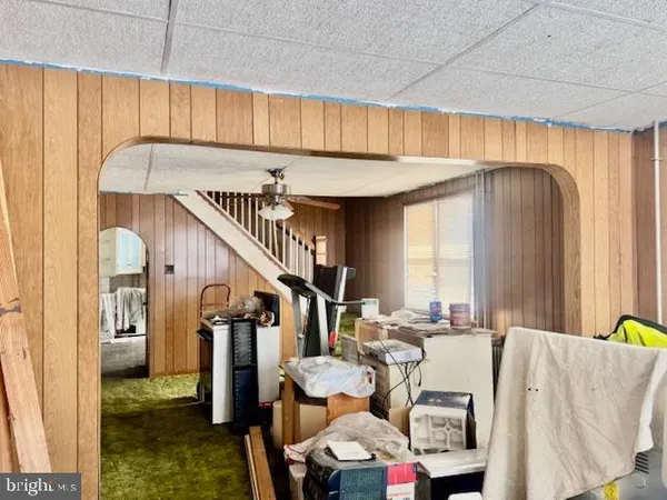 a view of living room kitchen and entryway