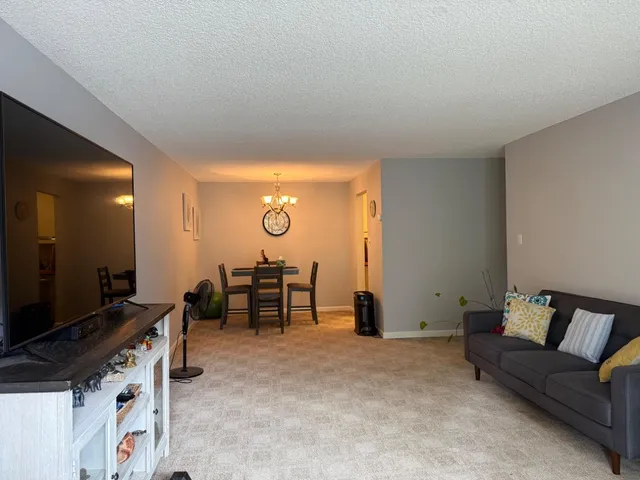 a view of a livingroom with furniture and a flat screen tv