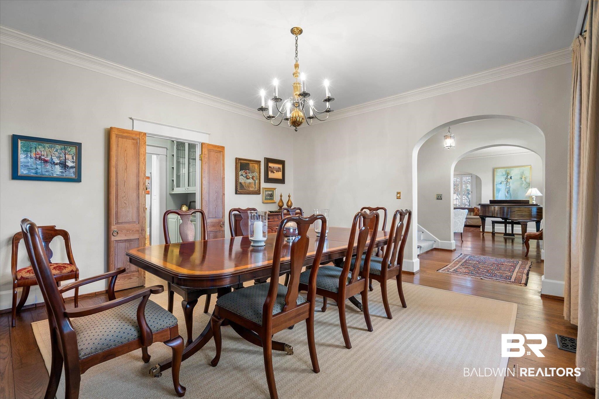 2 Westgate Road Mobile, AL 36608 - Photo 12 of 63 Dining space featuring hardwood / wood-style floors, ornamental molding, a chandelier, and arched walkways