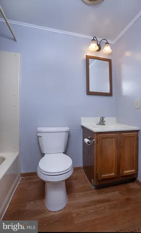 a bathroom with a toilet and a mirror