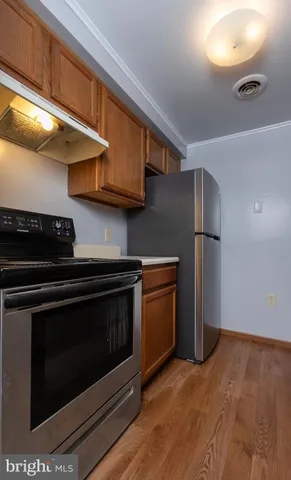 a kitchen with stainless steel appliances granite countertop a stove a refrigerator and a microwave