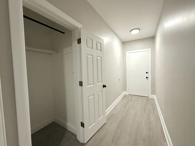 a view of a hallway with wooden floor